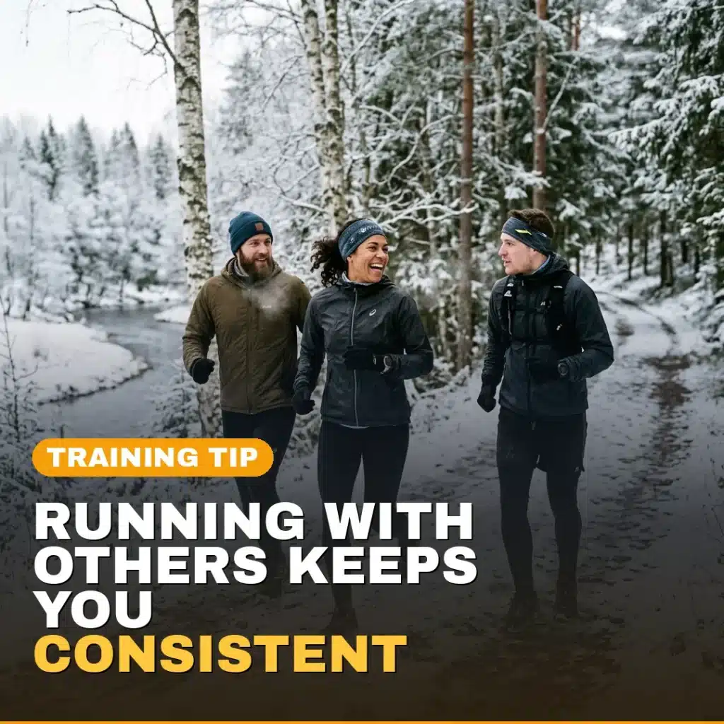 Three runners running together on a snowy winter trail